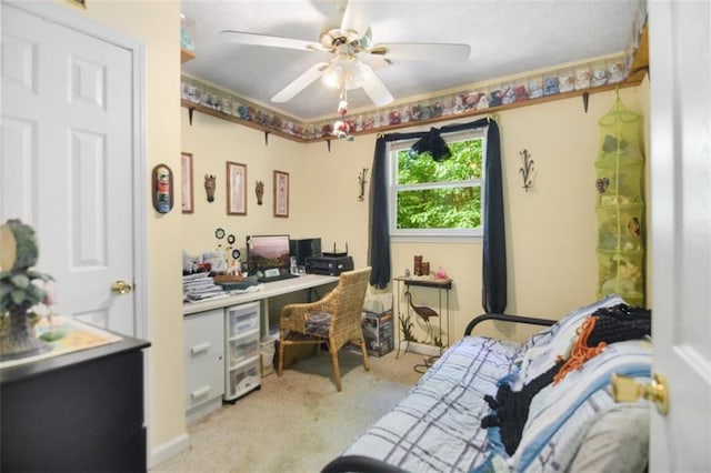 carpeted office space featuring ceiling fan