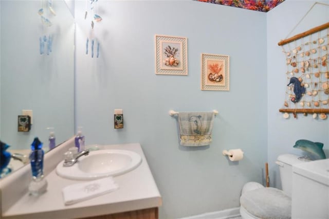 bathroom featuring vanity and toilet