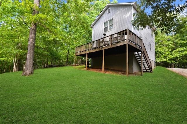 back of property featuring a wooden deck and a yard