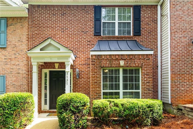 3737 Town Square Cir NW Unit 6, Kennesaw, GA 30144 - property entrance featuring brick siding, a standing seam roof, and a metal roof