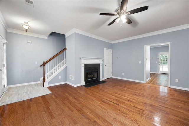 3737 Town Square Cir NW Unit 6, Kennesaw, GA 30144 - unfurnished living room with ceiling fan, wood finished floors, crown molding, a fireplace with flush hearth, and stairs