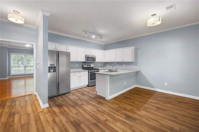 3737 Town Square Cir NW Unit 6, Kennesaw, GA 30144 - kitchen with stainless steel appliances, a peninsula, white cabinetry, dark wood finished floors, and ornamental molding