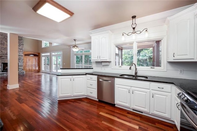 kitchen with sink, hanging light fixtures, stainless steel appliances, a healthy amount of sunlight, and white cabinets