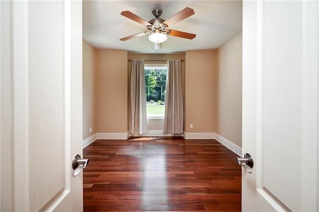 spare room with dark wood-type flooring and ceiling fan