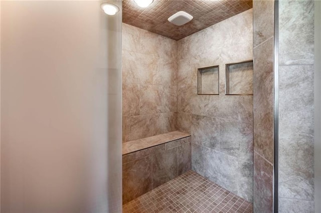 bathroom with tiled shower