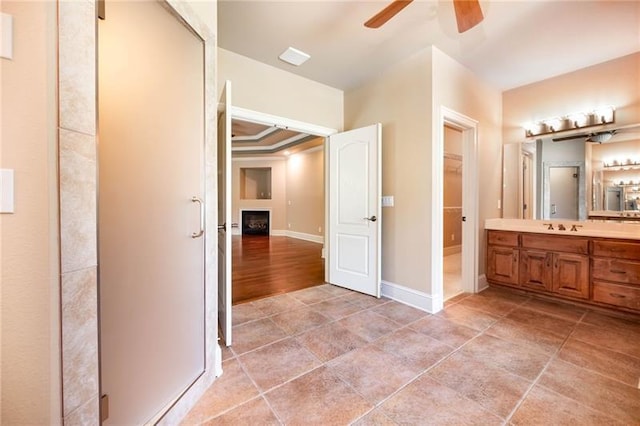 bathroom featuring ceiling fan, vanity, tile patterned flooring, and ornamental molding