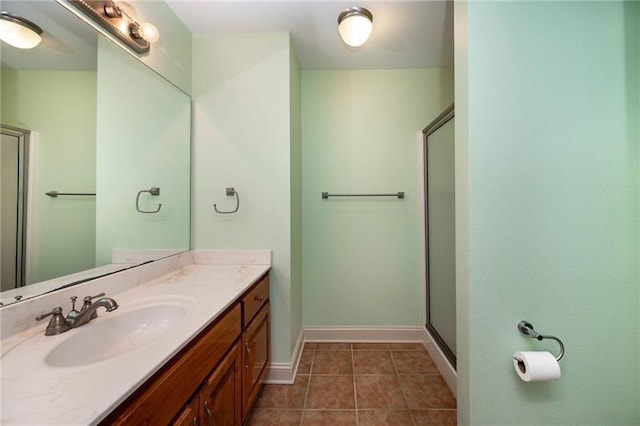 bathroom featuring walk in shower, tile patterned floors, and vanity