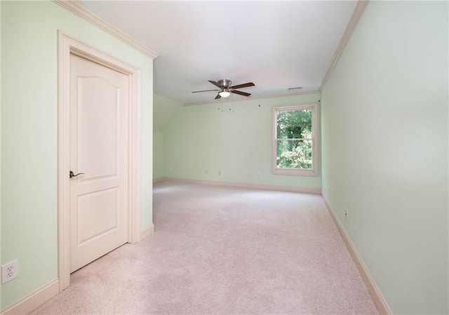 carpeted empty room featuring ceiling fan and ornamental molding