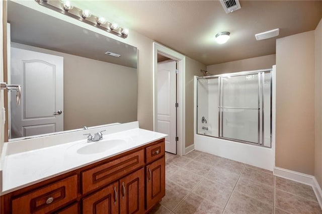 bathroom featuring vanity, tile patterned floors, and bath / shower combo with glass door