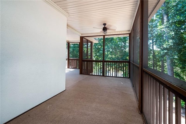 unfurnished sunroom featuring ceiling fan