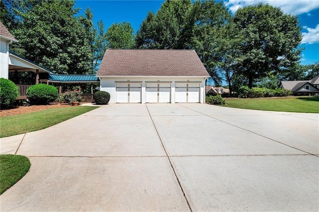 view of property exterior featuring a garage and a lawn