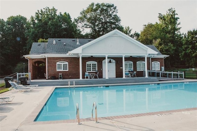 view of swimming pool featuring an outbuilding and a patio area