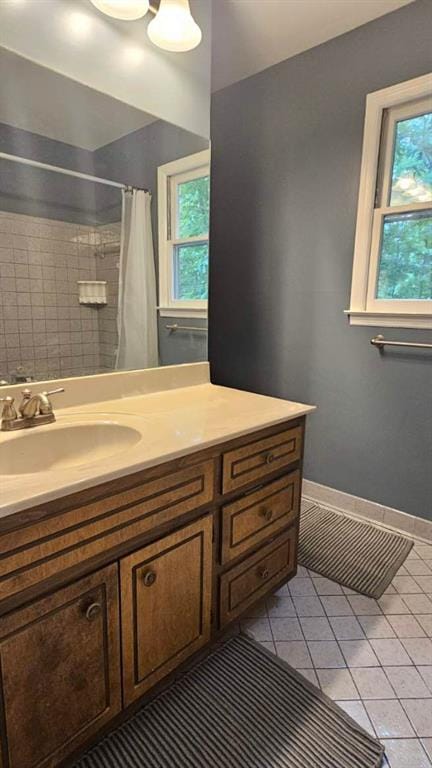 full bath with tile patterned flooring, vanity, and a shower with shower curtain