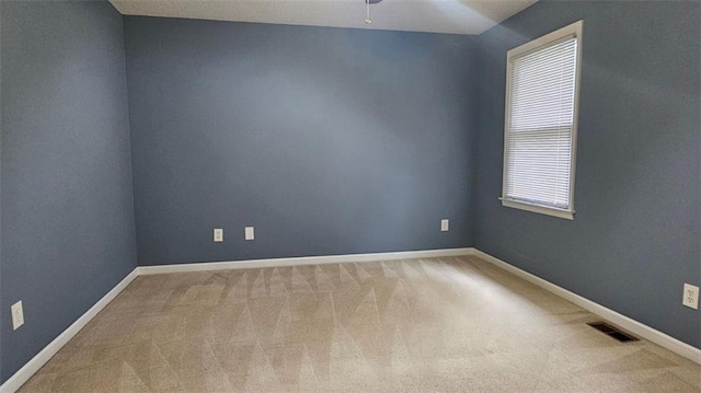 spare room with carpet flooring, a ceiling fan, and baseboards