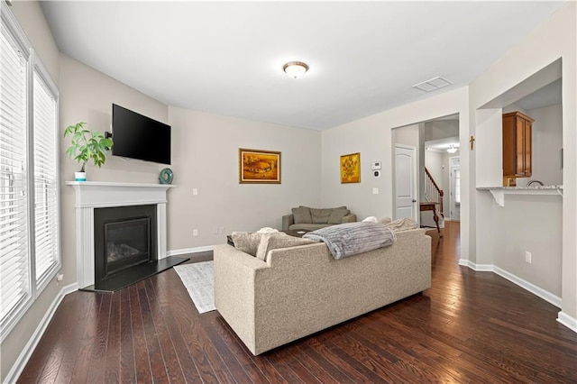1655 Hampton Oaks Dr, Alpharetta, GA 30004 - living room with dark wood finished floors, a glass covered fireplace, and stairway