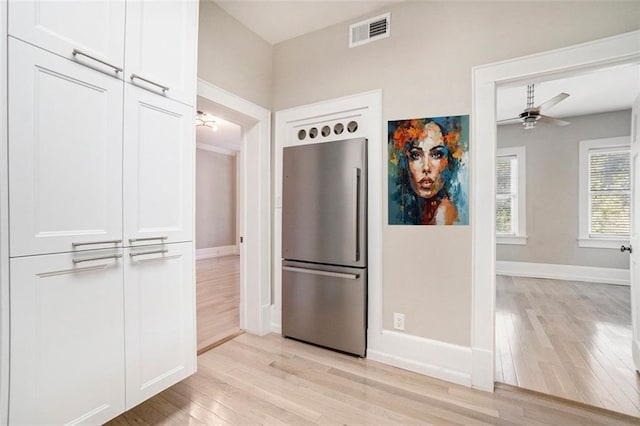 1156 Piedmont Ave NE Unit B3, Atlanta, GA 30309 - kitchen featuring freestanding refrigerator, light wood-type flooring, white cabinets, ceiling fan, and baseboards