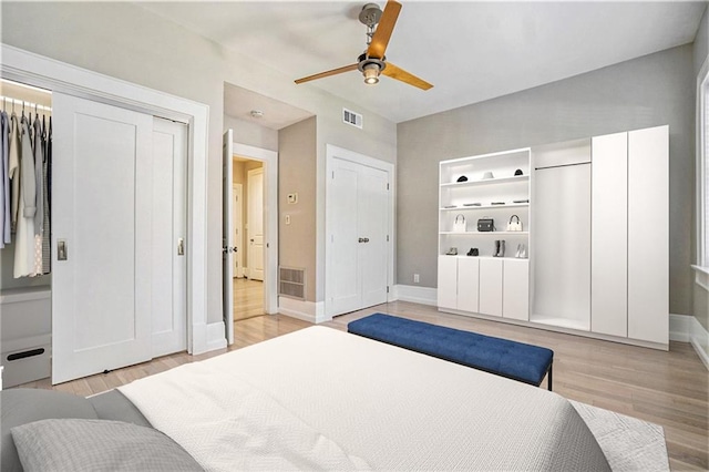 1156 Piedmont Ave NE Unit B3, Atlanta, GA 30309 - bedroom featuring baseboards, light wood-style flooring, two closets, and ceiling fan