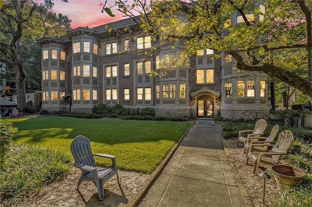 1156 Piedmont Ave NE Unit B3, Atlanta, GA 30309 - back of property at dusk with french doors, a yard, and stone siding