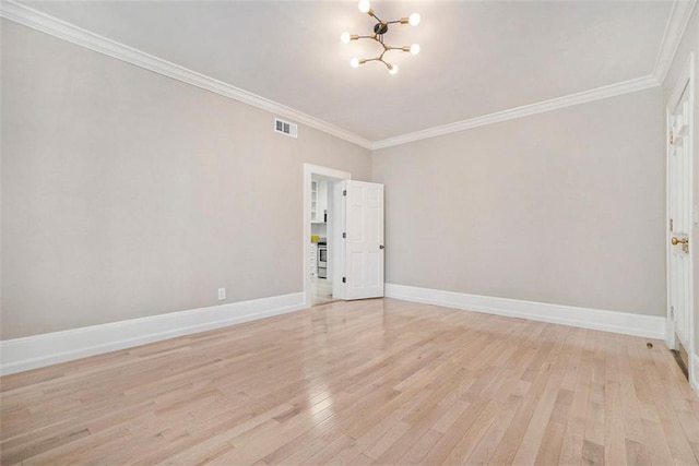 1156 Piedmont Ave NE Unit B3, Atlanta, GA 30309 - spare room featuring a chandelier, light wood-style flooring, ornamental molding, and baseboards