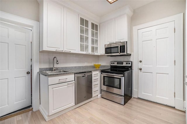 1156 Piedmont Ave NE Unit B3, Atlanta, GA 30309 - kitchen with stainless steel appliances, a sink, white cabinets, and backsplash