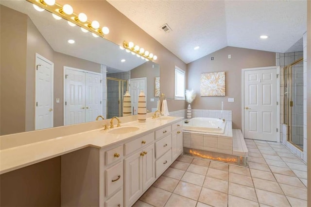 bathroom featuring a sink, vaulted ceiling, visible vents, a bath, and a stall shower