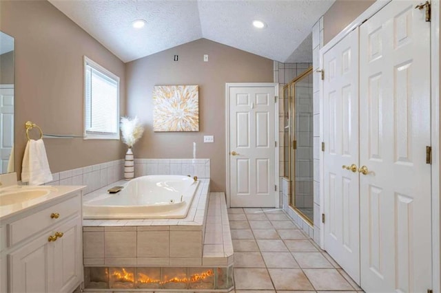 full bath with vanity, a garden tub, a stall shower, and lofted ceiling