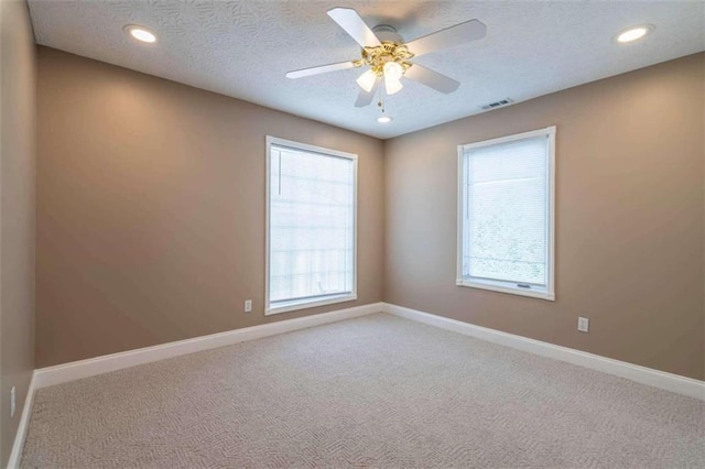 unfurnished room with baseboards, visible vents, and carpet