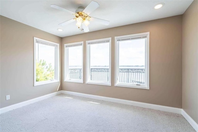 carpeted spare room featuring a ceiling fan, baseboards, and recessed lighting