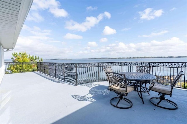 view of patio with outdoor dining area and a water view