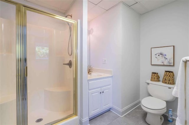 full bathroom with vanity, baseboards, a stall shower, and toilet