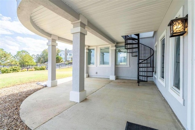 view of patio / terrace with stairway and fence