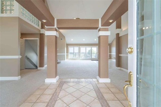 entrance foyer with light colored carpet, recessed lighting, baseboards, and ornate columns