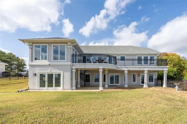 back of house featuring fence, stucco siding, a deck, a patio area, and a yard