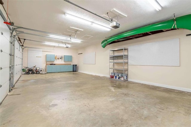 garage with baseboards and a garage door opener