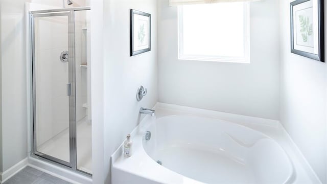 bathroom featuring shower with separate bathtub