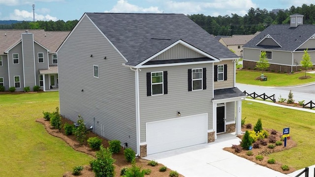 view of front of property featuring a garage and a front yard