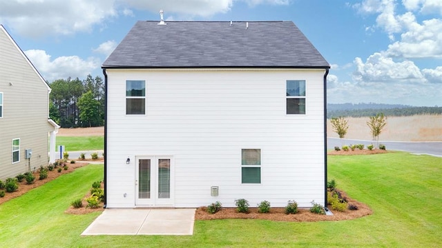 rear view of house featuring a patio area and a lawn