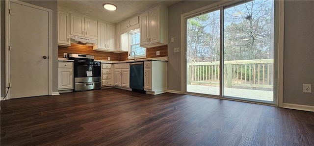 kitchen with under cabinet range hood, white cabinets, stainless steel gas range, dishwasher, and dark wood finished floors