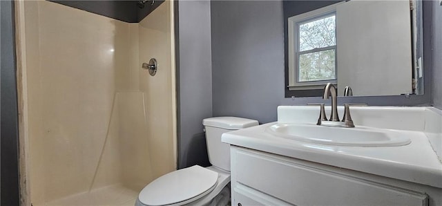 bathroom featuring a stall shower, vanity, and toilet