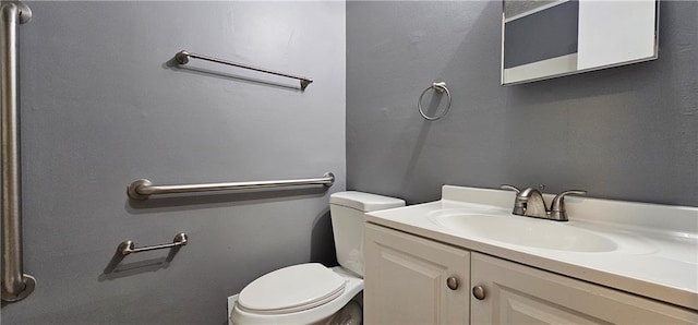 half bath featuring vanity and toilet