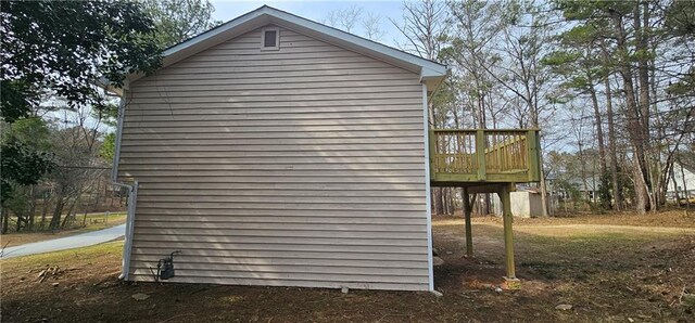 view of side of home with a wooden deck