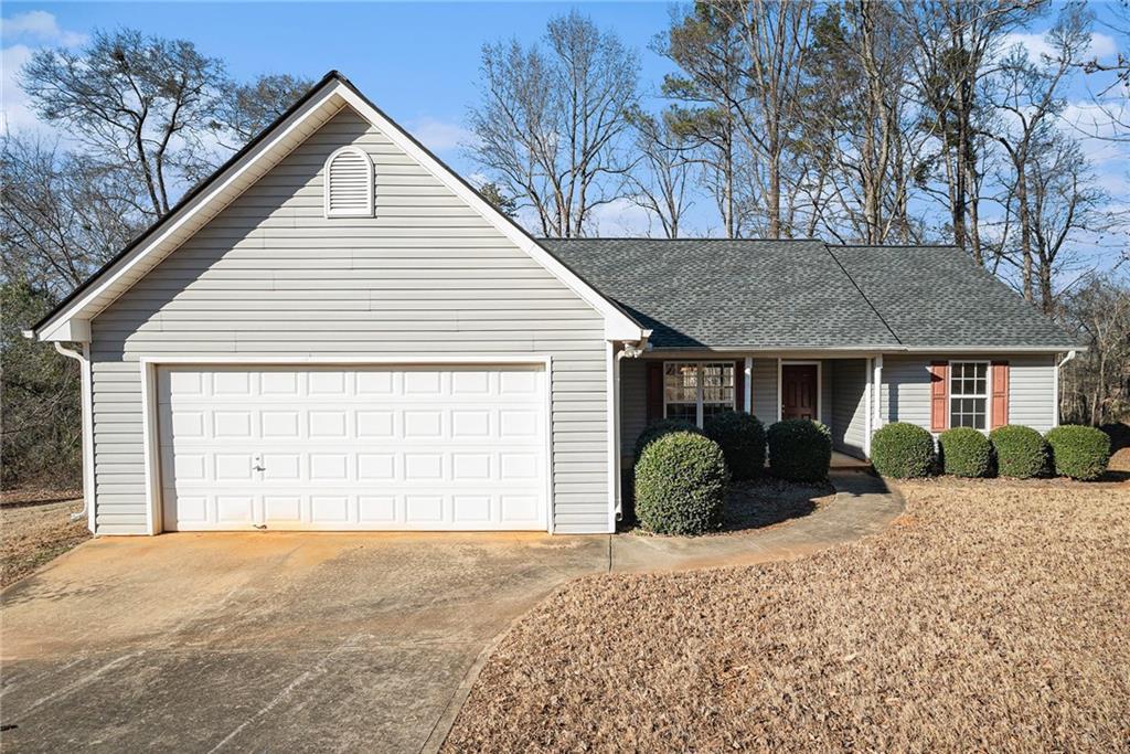 ranch-style house featuring a garage