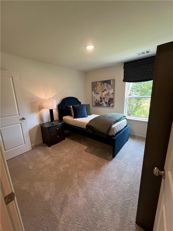1567 Aiden Way Unit 34, Conyers, GA 30013 - carpeted bedroom featuring baseboards and recessed lighting
