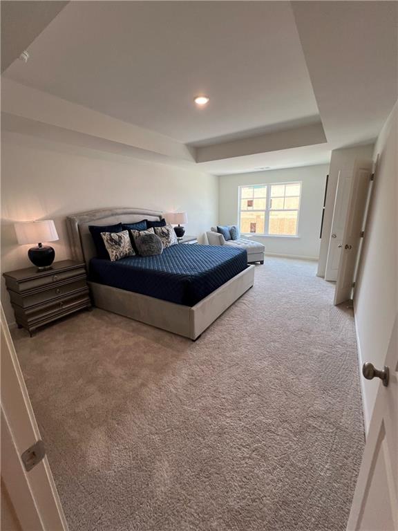 1567 Aiden Way Unit 34, Conyers, GA 30013 - bedroom featuring carpet, a tray ceiling, recessed lighting, and baseboards