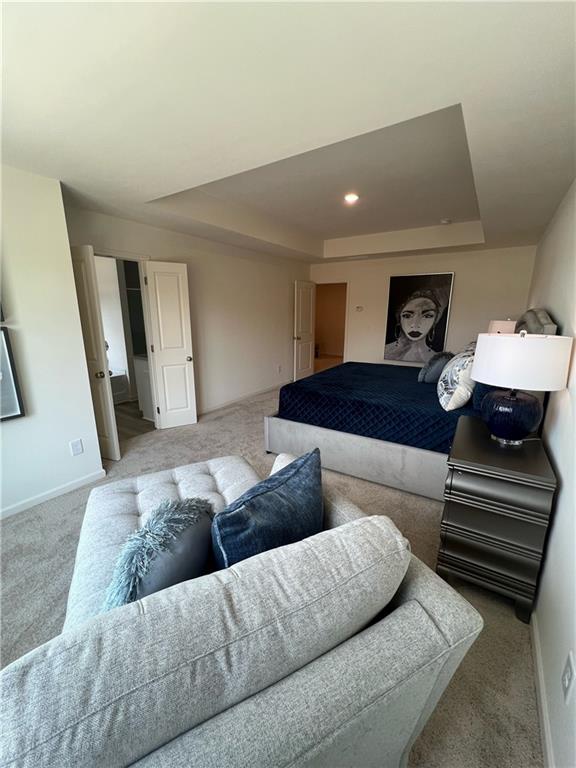 1567 Aiden Way Unit 34, Conyers, GA 30013 - bedroom with a raised ceiling, carpet, and baseboards
