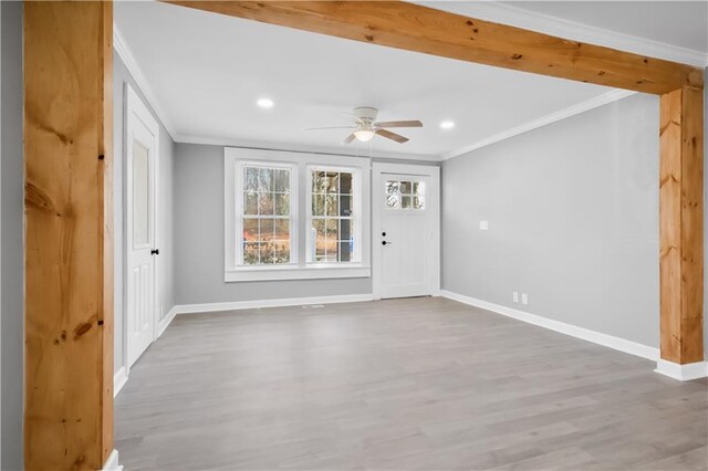 spare room with hardwood / wood-style flooring, ceiling fan, and ornamental molding