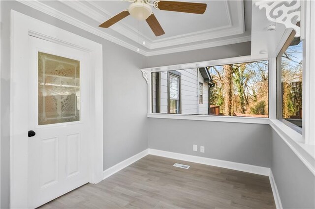 interior space with a tray ceiling and ceiling fan