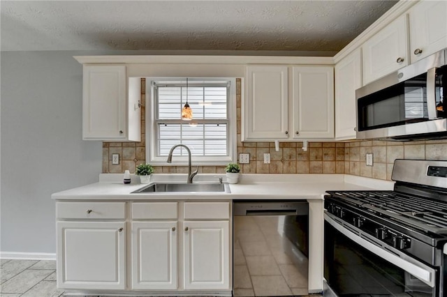 1965 Sterling Creek Ct, Snellville, GA 30078 - kitchen featuring appliances with stainless steel finishes, a sink, white cabinetry, tasteful backsplash, and light countertops