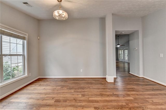 1965 Sterling Creek Ct, Snellville, GA 30078 - unfurnished room with wood finished floors, baseboards, a ceiling fan, and a textured ceiling