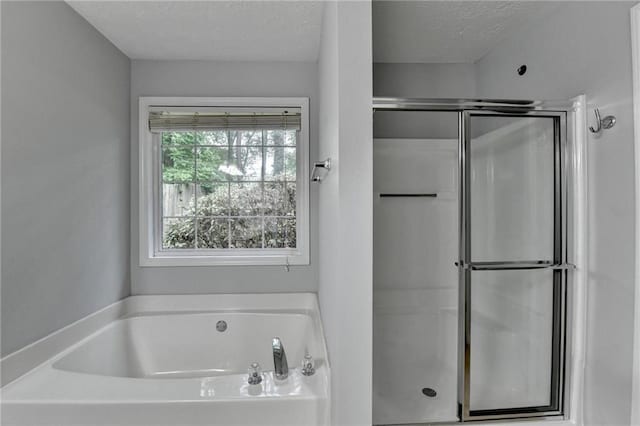 1965 Sterling Creek Ct, Snellville, GA 30078 - bathroom featuring a garden tub, a stall shower, and a textured ceiling